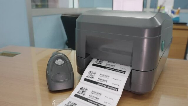 The black barcode printer is printing the bar code or QR code on the sticker.