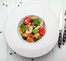 Salad with fish fillet, orange, olives, spinach and shrimps
