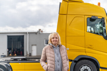Caucasian mid age woman driving truck. trucker female worker, transport industry occupation 
