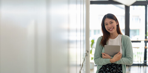 Portrait of young happy attractive asian student smiling and looking at camera. Asian woman in self future education or personalized learning concept. banner