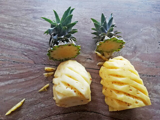 Cuted off,opened of pineapple,placed on brown wooden background