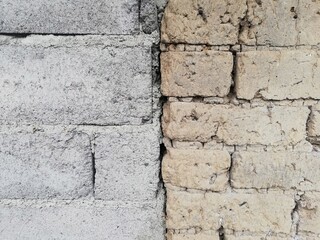 Two types of wall materials,stone and clay in close up,old and modern concept