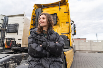 Caucasian young woman driving truck. trucker female worker, transport industry occupation 