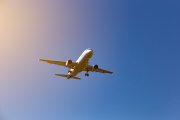 Airplane flying on the blue sky background.