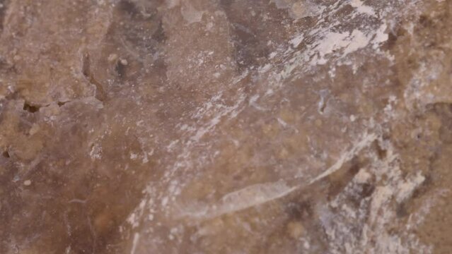 Flint stone surface texture macro shot, very close up view with rotating motion studio shot.