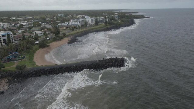 Waves Splashing On The Shore Of Bundaberg Coastal Town In Queensland, Australia - aerial drone shot