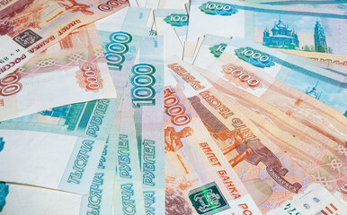 horizontal background of paper money spread out in a fan in denominations of one thousand and five thousand Russian rubles