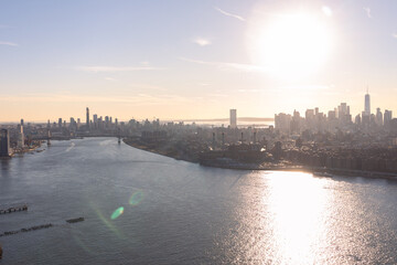 Fototapeta premium Aerial View of the Manhattan Skyline Between Brooklyn along the East River in New York City during a Sunset