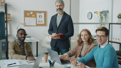 Portrait of office workers creative team in modern office looking at camera with happy faces smiling. Business and teamwork concept.