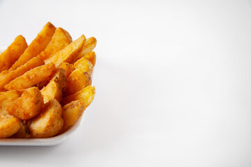 French fries are in the plate. On a white background. Copy space.