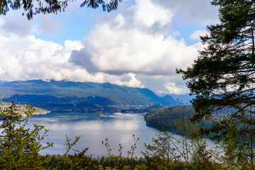 Fototapeta na wymiar Spectacular forest and water scenery viewed from Burnaby Mountain Park, BC, during Spring.