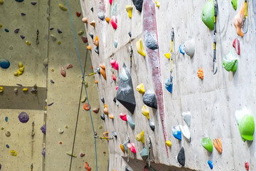 Artificial rock climbing wall with various colored grips.