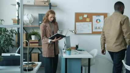 Diverse group of serious businesspeople working in modern office together concentrated on job. Workplace and professional occupation concept.