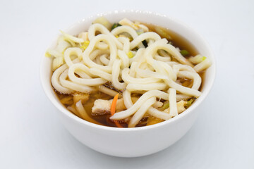 Japanese Style Chicken Udon Noodle Soup in Bowl with a White Background