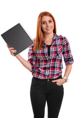 Smiling young redhead woman holding a notebook