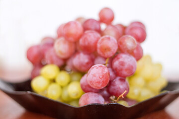 Red and White wine bunch of grapes in the black plate