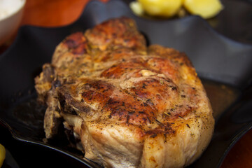 Juicy ready roasted steak on the black plate in the kitchen