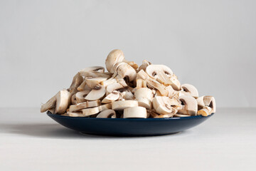 Heap of chopped white champignon mushrooms on a plate