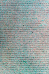 A sheet of green and brown paper close-up, macro paper fibers, background with horizontal stripes