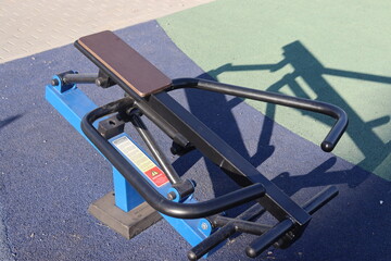 trainers and horizontal bars in city yard