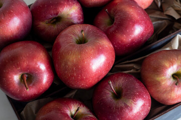 Juicy ripe tasty red apples in a box. Top view. A bountiful harvest.