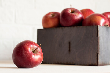 Red delicious ripe fresh apples on the table and in a box. Harvest