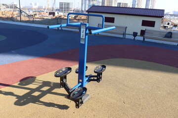 trainers and horizontal bars in city yard