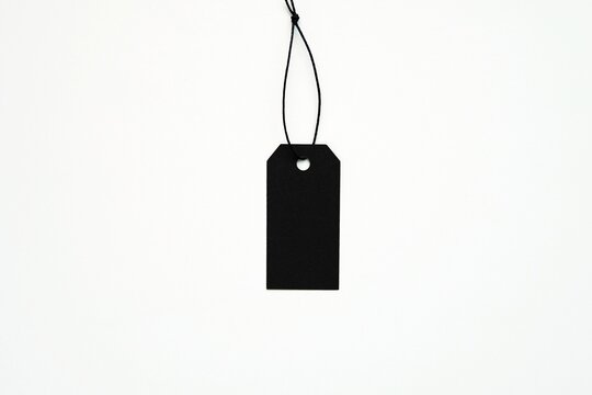 Black empty price tag hanging on black string, product hangtag mockup, Black Friday sale concept.