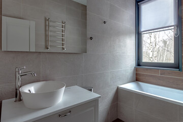 Fototapeta na wymiar Modern scandinavian bathroom interior with stylish mirror and vessel sink