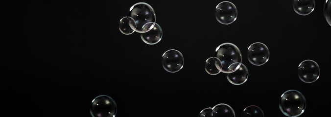 Soap bubble drop or Shampoo bubbles floating like flying in the air black background which represent refreshing moments and gentle soft. Bubbles drops for soap  shampoo or detergent product industry. - obrazy, fototapety, plakaty