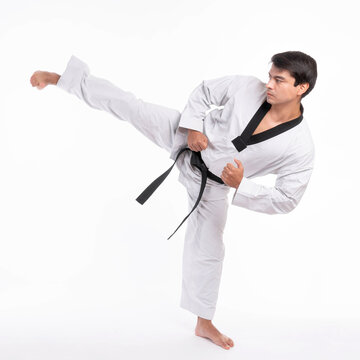 Taekwondo High Kick - Black Belt  Taekwondo Athlete Martial Arts Master , Handsome Man Show High Kick Pose During Fighter Training Isolated On White Background With Copy Space