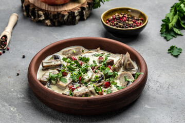 Slow cooked pork stew with mushrooms in creamy sauce served with parsley. Restaurant menu, dieting, cookbook recipe top view