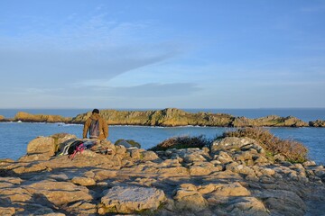 Man watching the sea at "Pointe du Grouin" Cancale in Brittany France