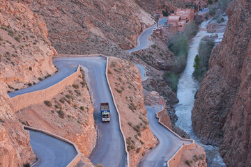 Road on the Dades gorge in Morocco with a crossing truck