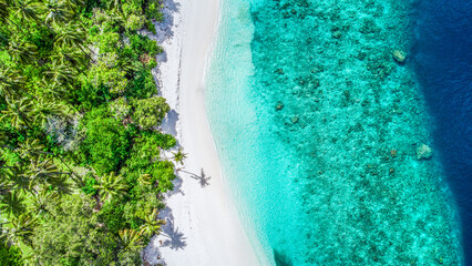 Aerial view to the small islands surrounded by cristal clear waters around Maldives
