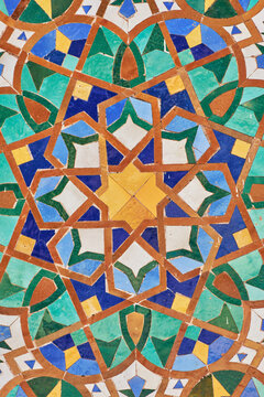 Detail of a moroccan painted multi-coloured traditional mosaic-tiled wall in blue, green, yellow, brown. Morocco