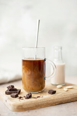 black coffee with almond milk in a glass mug