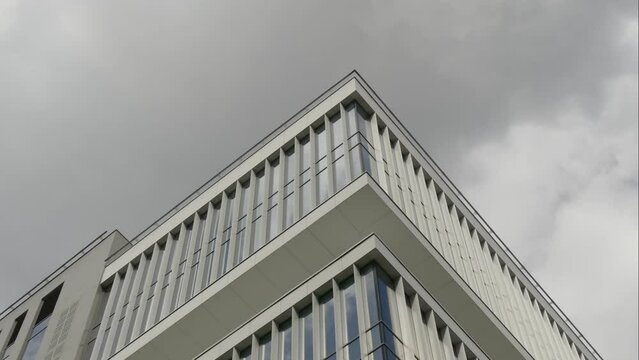 Exterior of a high-rise apartment building facade, windows and balconies.