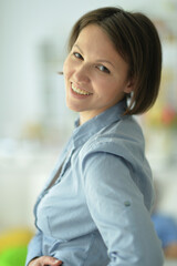 Portrait of beautiful young woman posing at home