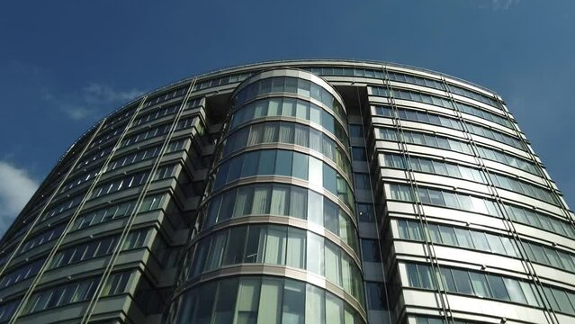 Exterior of a high-rise apartment building facade, windows and balconies.
