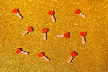 clothespins with hearts on a yellow iridescent background.