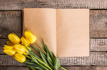 Open blank book and tulips