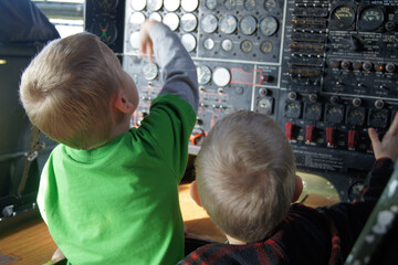 children playing in airplane cockpit