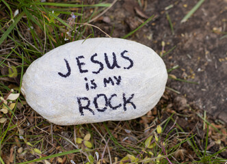 Jesus is my rock, a handwritten text, bible verse on a stone in nature. Christian biblical concept....
