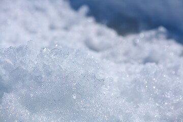 Snow crystalline background close-up. White with blue.