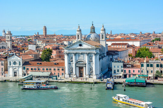 Tourists in the entrance of the classical style 18th-century Dominican church, Santa Maria del Rosario (St. Mary of the Rosary), on the Canale della Giudecca (Giudecca Canal).