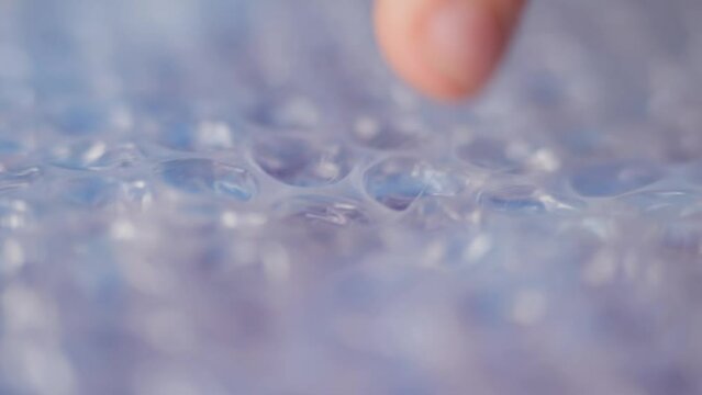 Relaxation, children's fingers press on the bubbles on the wrapping film. Calming effect.