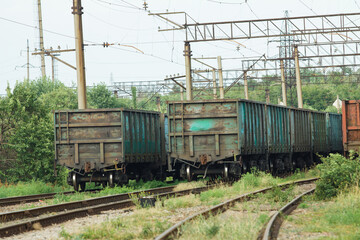 Fototapeta na wymiar Old multicolored freight cars at the marshalling yard in the summertime