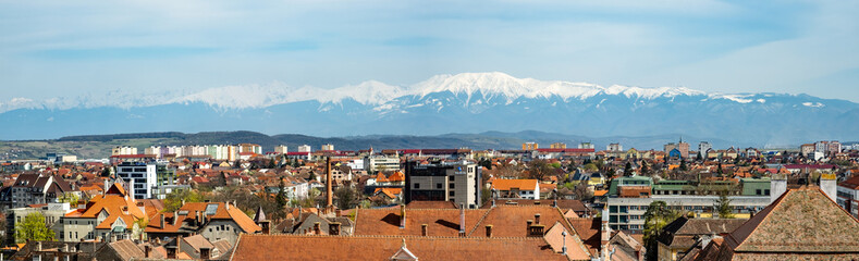 Naklejka na ściany i meble Panoramic view of the Sibiu city with snow covered Fagaras mountains in the back, part of the Carpathian mountains, Romania