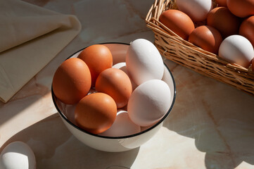 Basket with eggs. White and brown eggs in a wicker basket. Cooking process. Simple composition with food